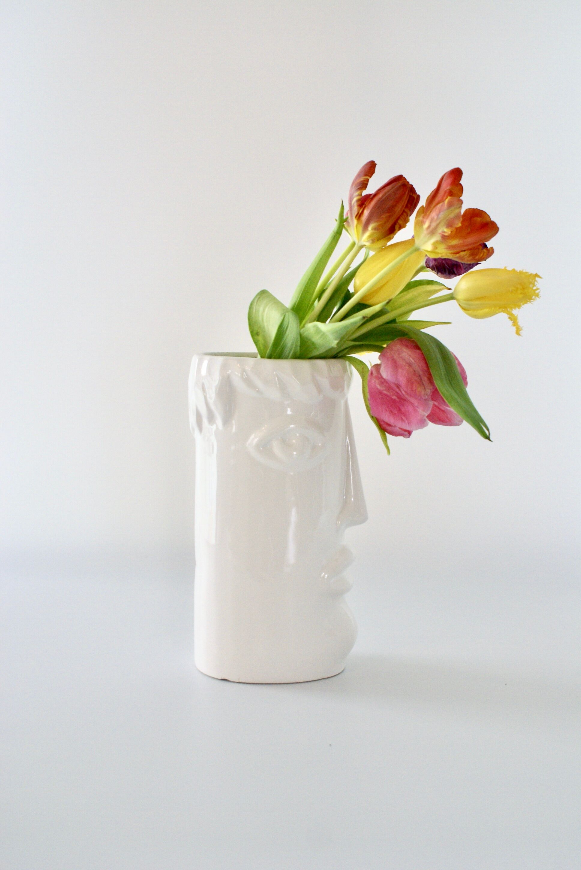 White glazed ceramic vase with face
