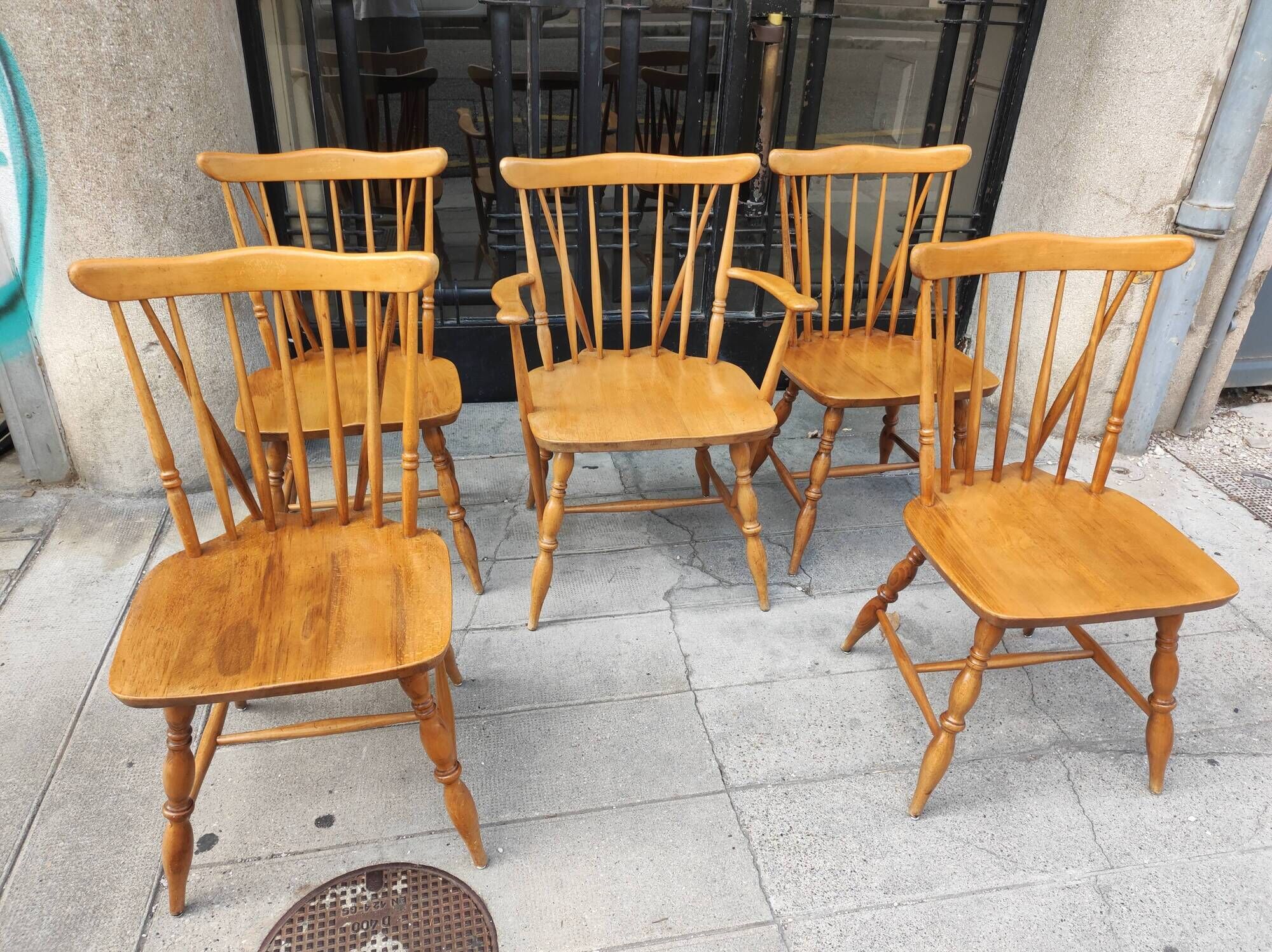 Four chairs and a Heywood Wakefield Windsor armchair. Vintage