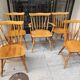 Four chairs and a Heywood Wakefield Windsor armchair. Vintage