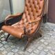 Chesterfield armchair in leather and carved solid wood