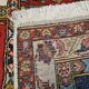Handmade Persian carpet, featuring animal and plant motifs.