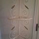 Cream and brass corner bakery shelf in wrought iron