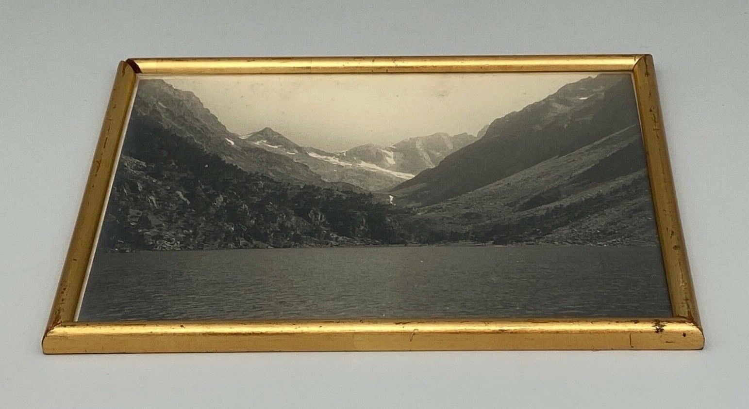 Photo in black and white mountain lake in golden frame