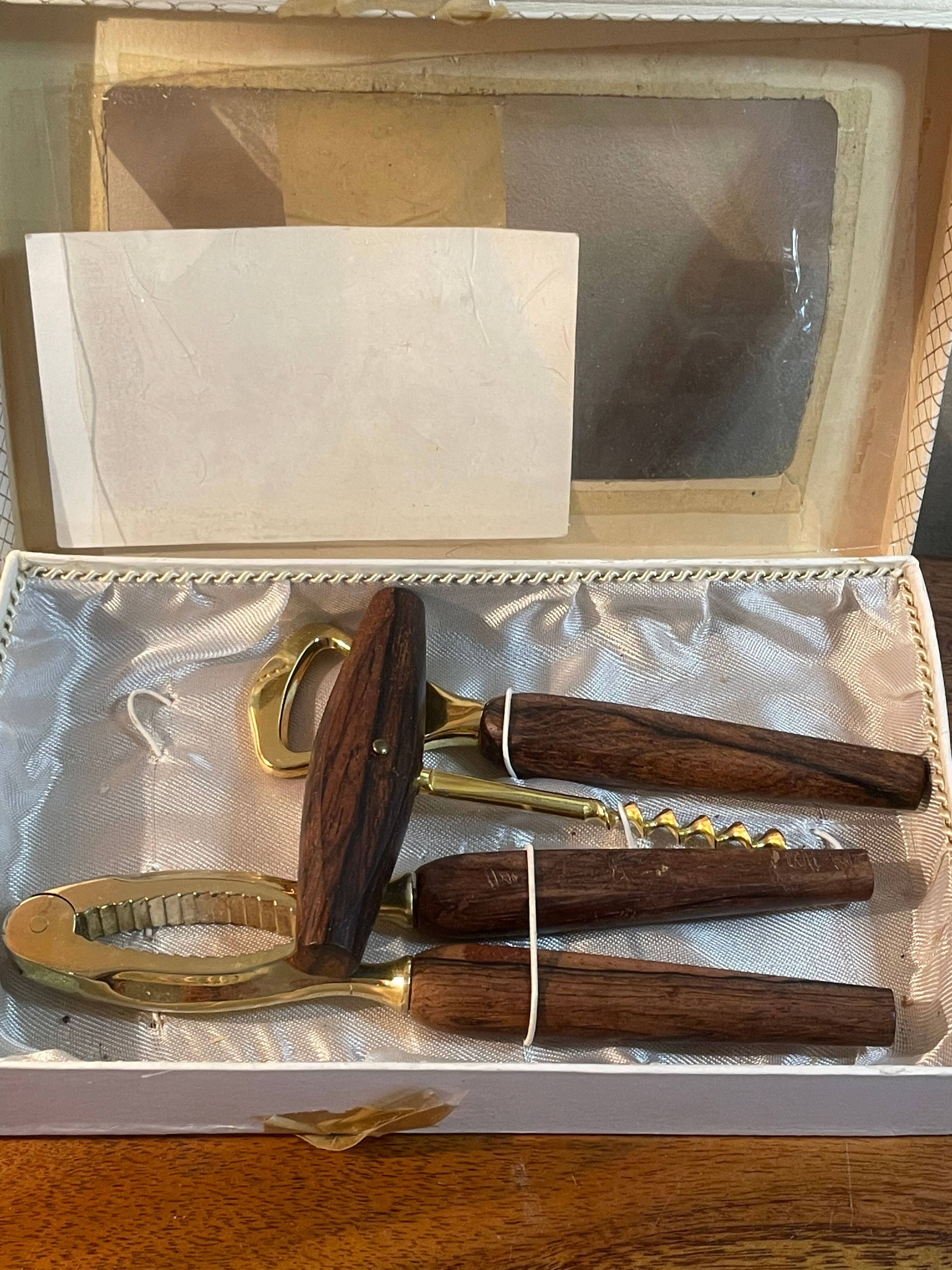 Bottle opener made of teak wood, corkscrew and nutcracker