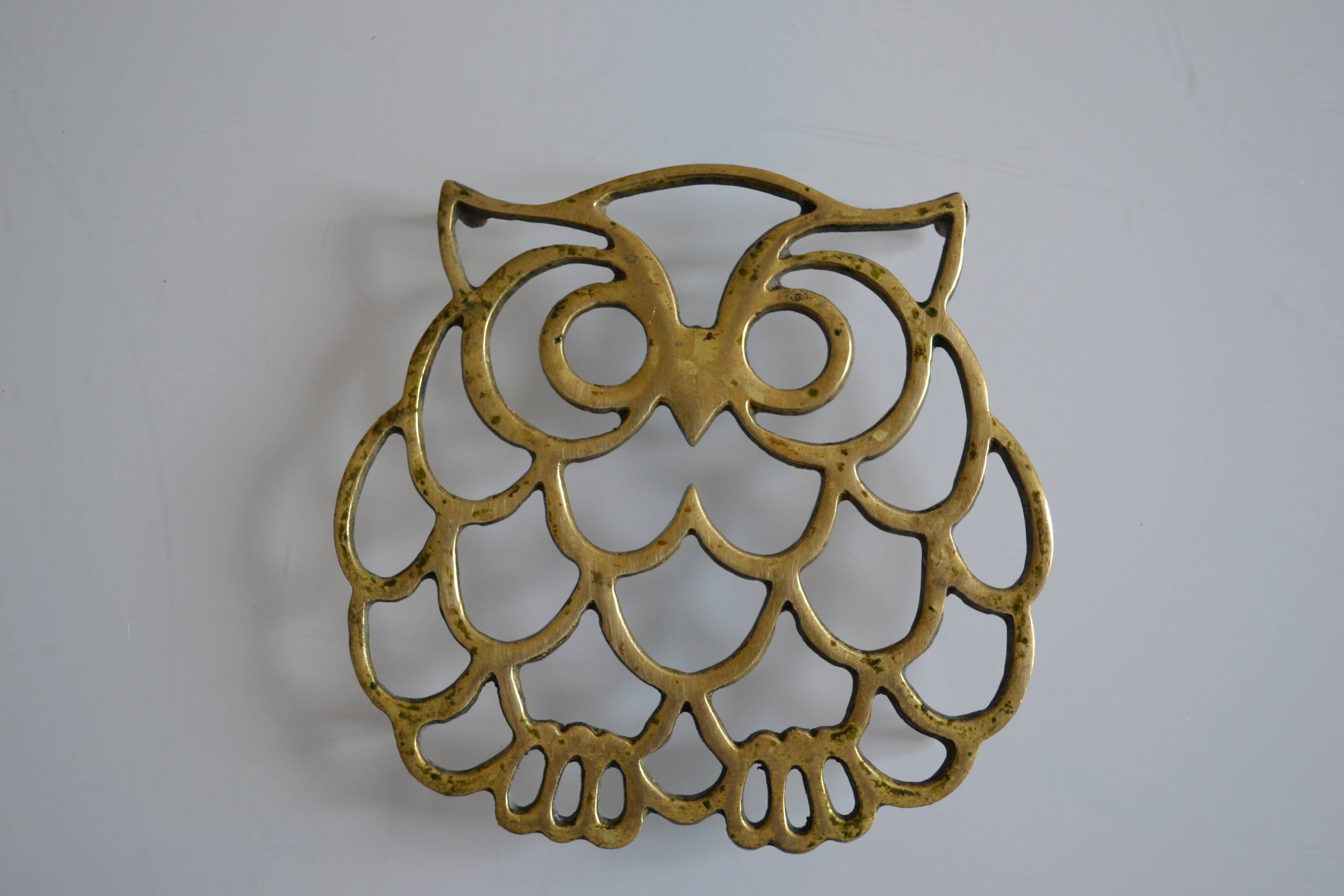 Vintage openwork brass trivet in the shape of an owl or owl
