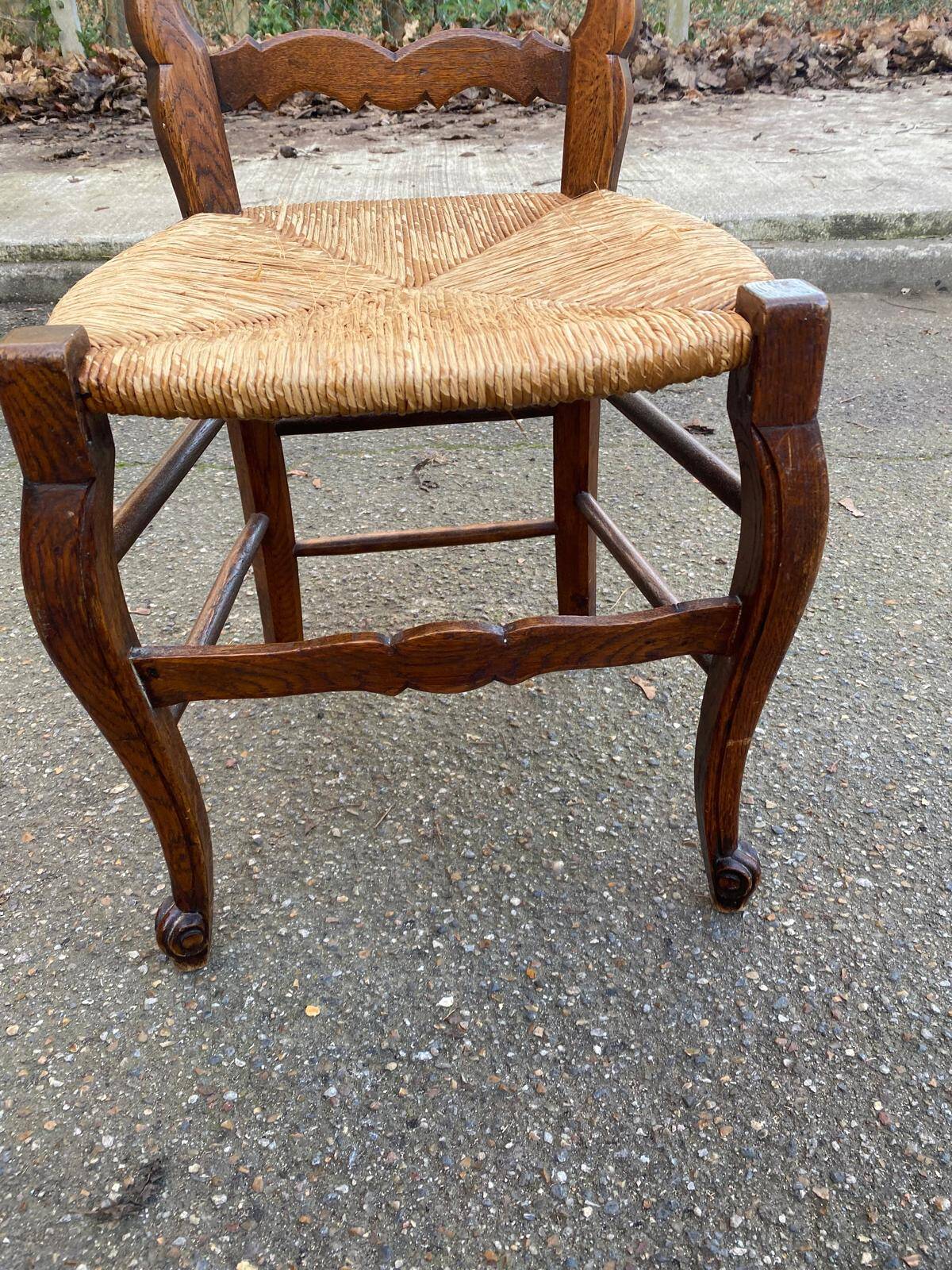 Louis XV 18th century solid wood dining chair with a straw seat.