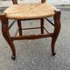 Louis XV 18th century solid wood dining chair with a straw seat.