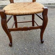 Louis XV 18th century solid wood dining chair with a straw seat.
