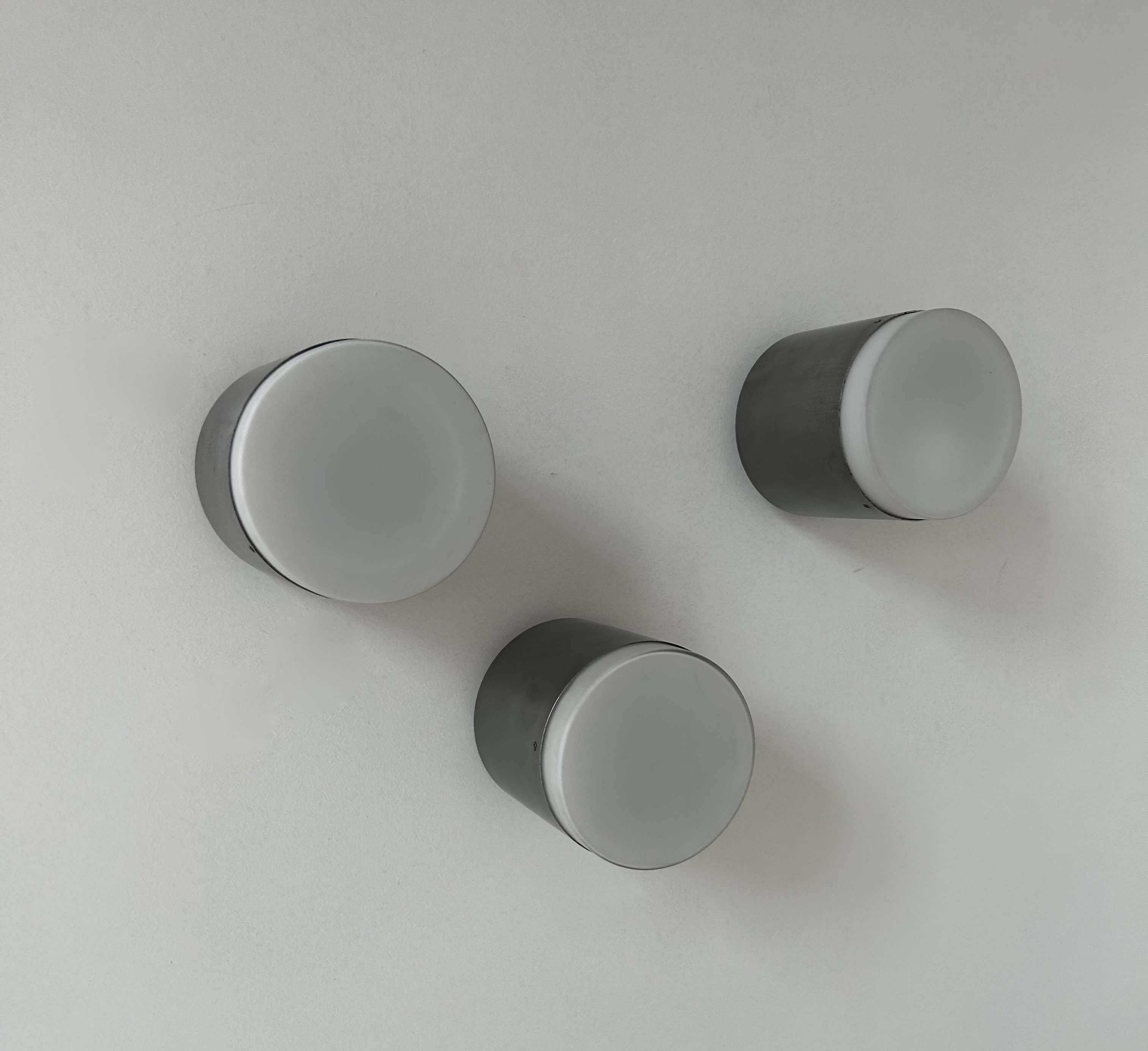 Set of 3 vintage Raak wall lights, aluminum and opaline, Holland 1960