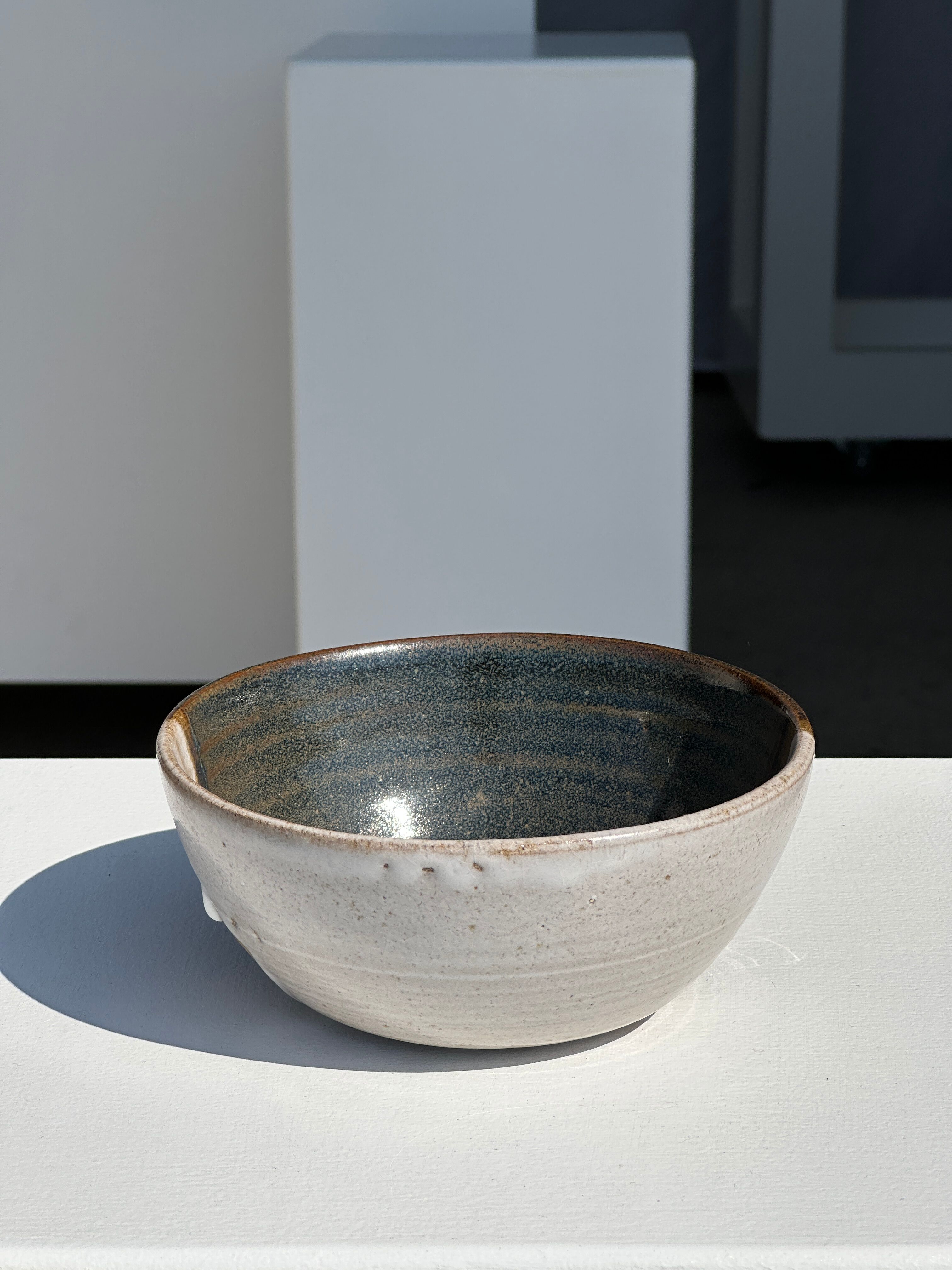 White and glossy brown two-tone ceramic bowl, matt earth