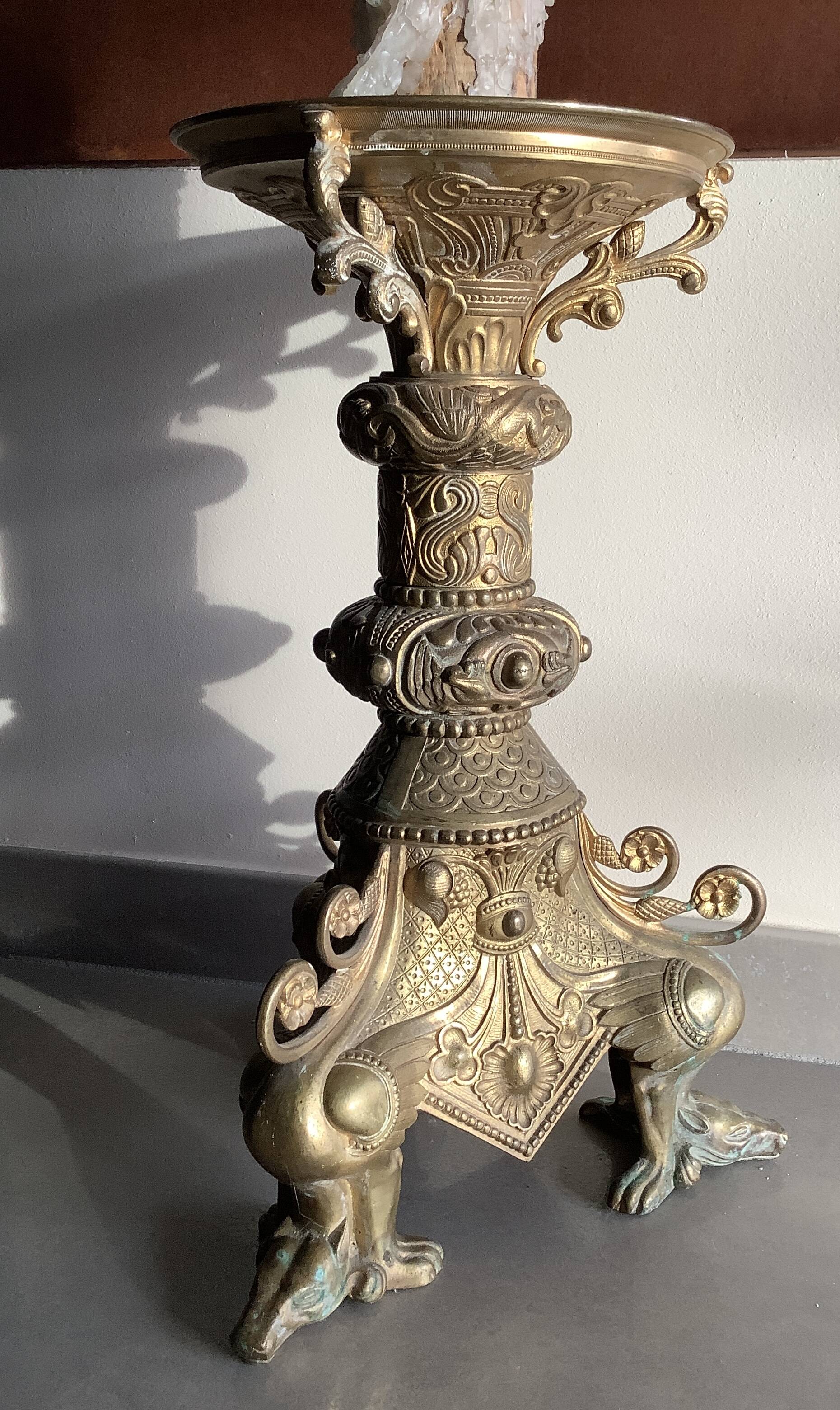 Large bronze candlestick with tripod and winged dog decoration, 19th century.