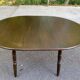 Extendable round table in solid wood with a dark oak satin finish.