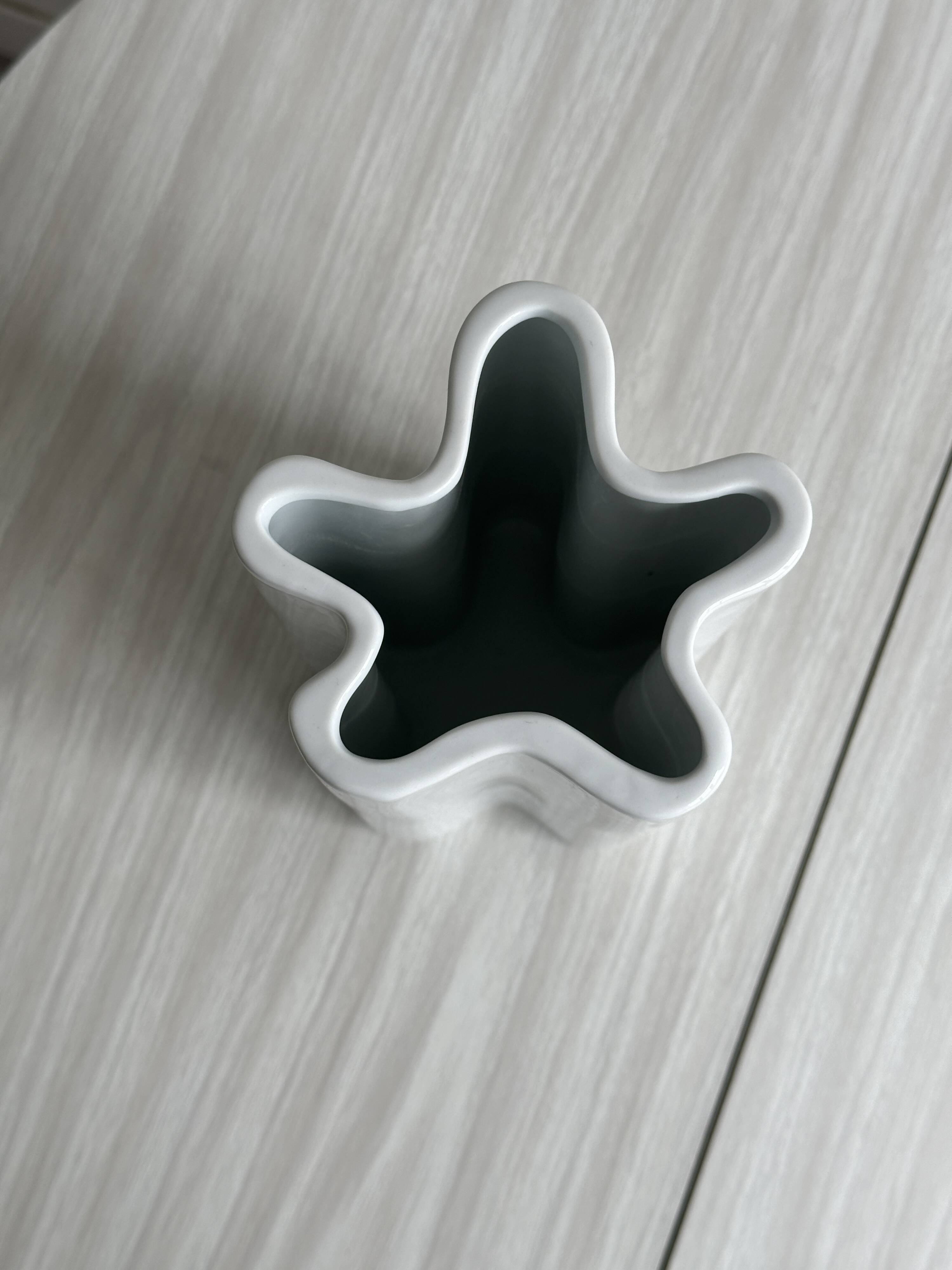 Modern white ceramic vase with wavy curves