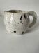 Small speckled ceramic jug in a vintage workshop style.