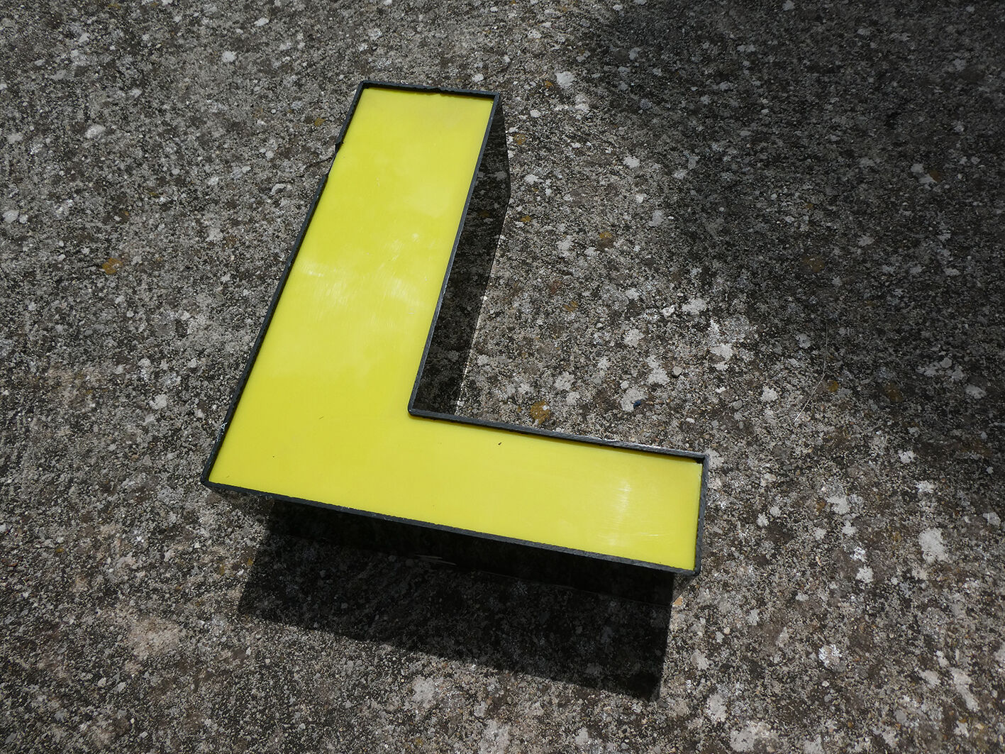 Letter "l" of industrial sign yellow and black