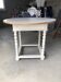 Antique round table refurbished in cerused white, with twisted legs.