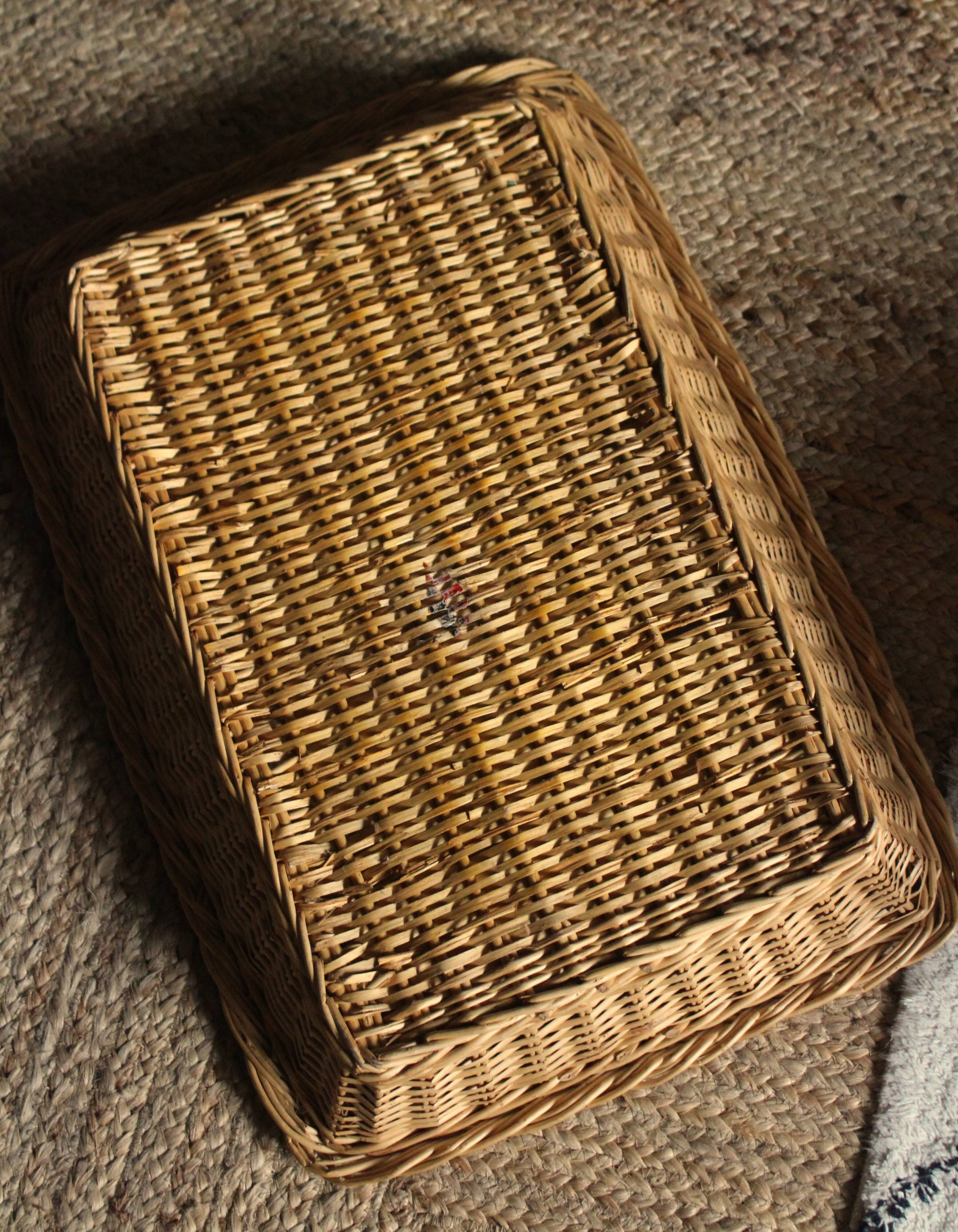 A large vintage rectangular wicker basket
