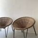 Italian basket chair in rattan and black metal, 1950s design.