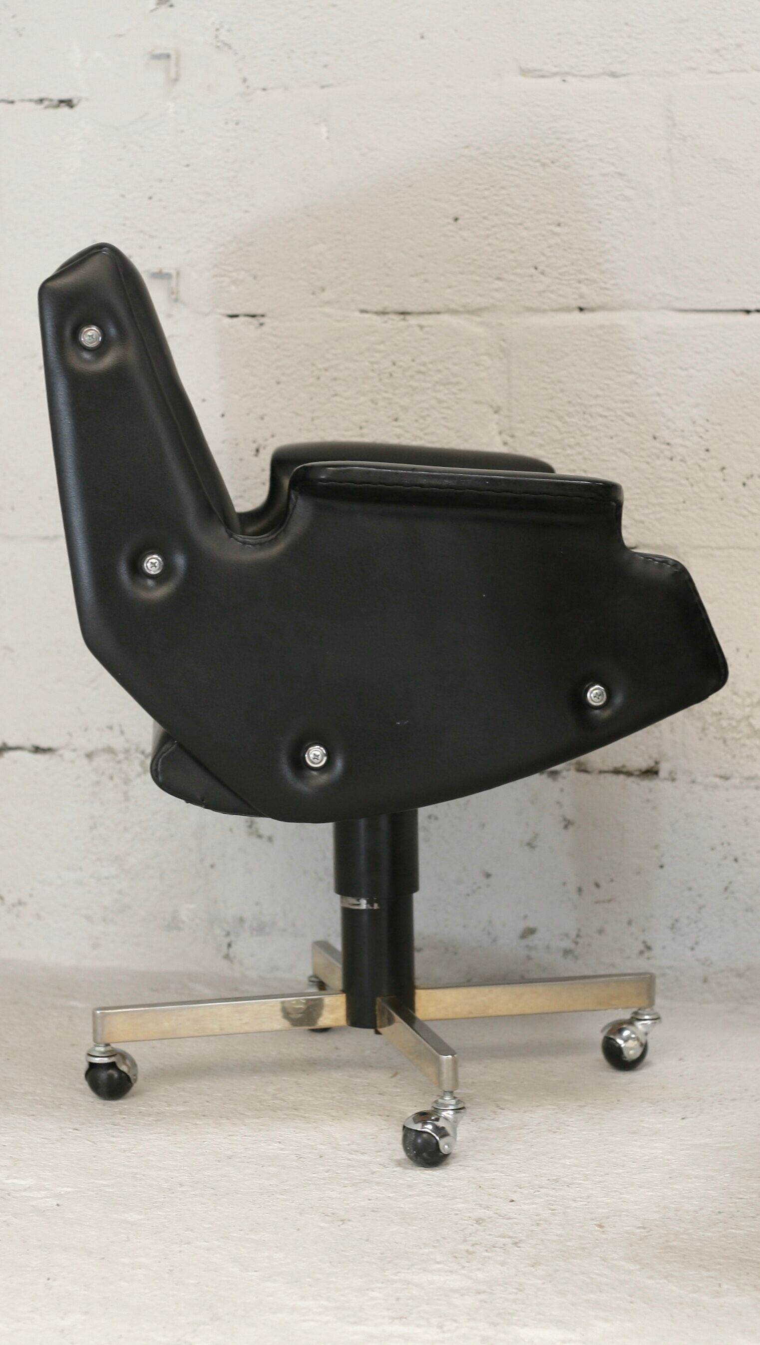 Pair of swivel armchairs, imitation leather and steel, Italy, circa 1960.