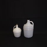 Pair of white covered demijohns