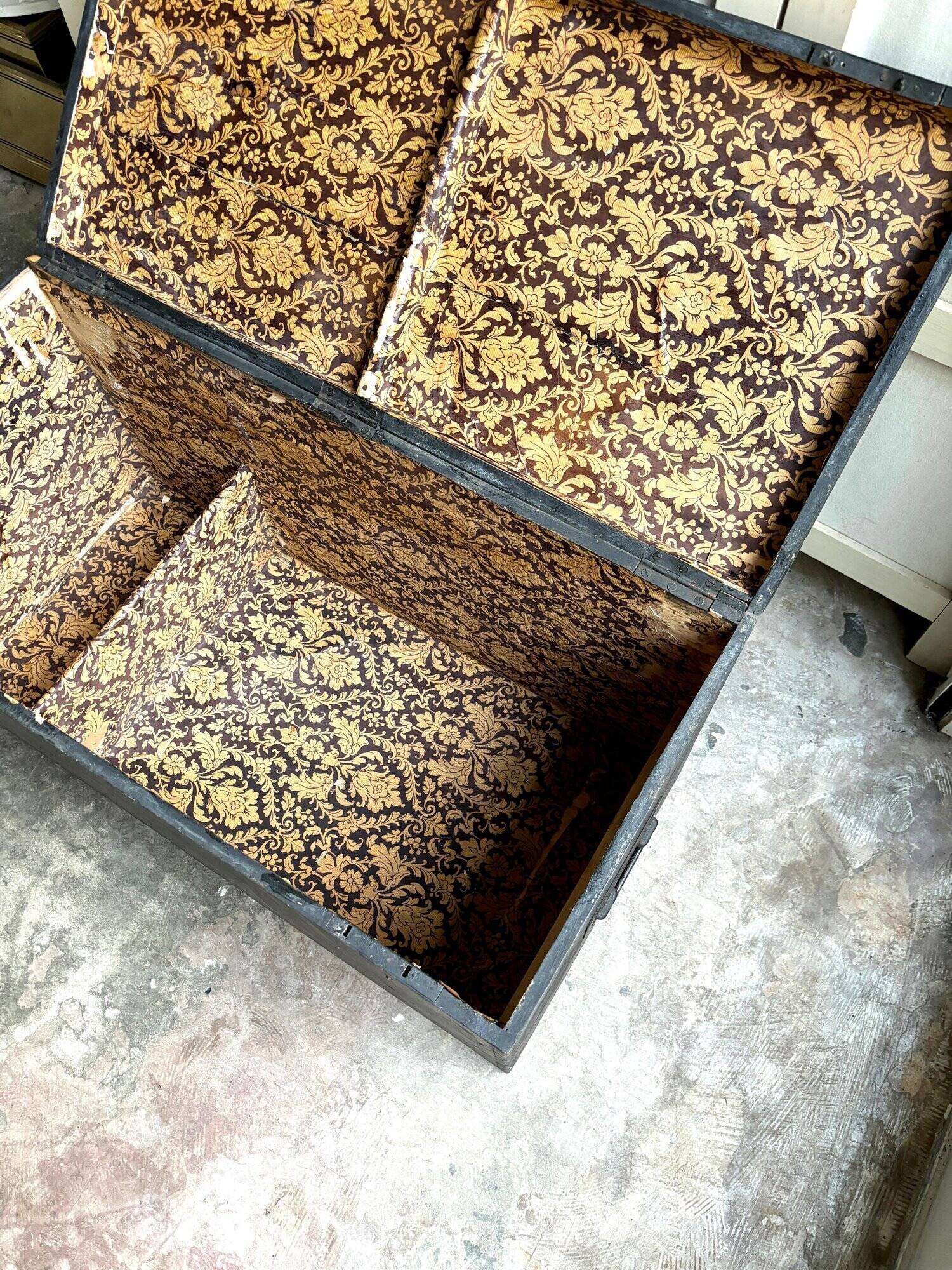 Trunk, black wooden chest and wallpaper