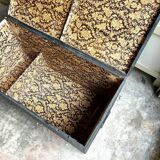 Trunk, black wooden chest and wallpaper