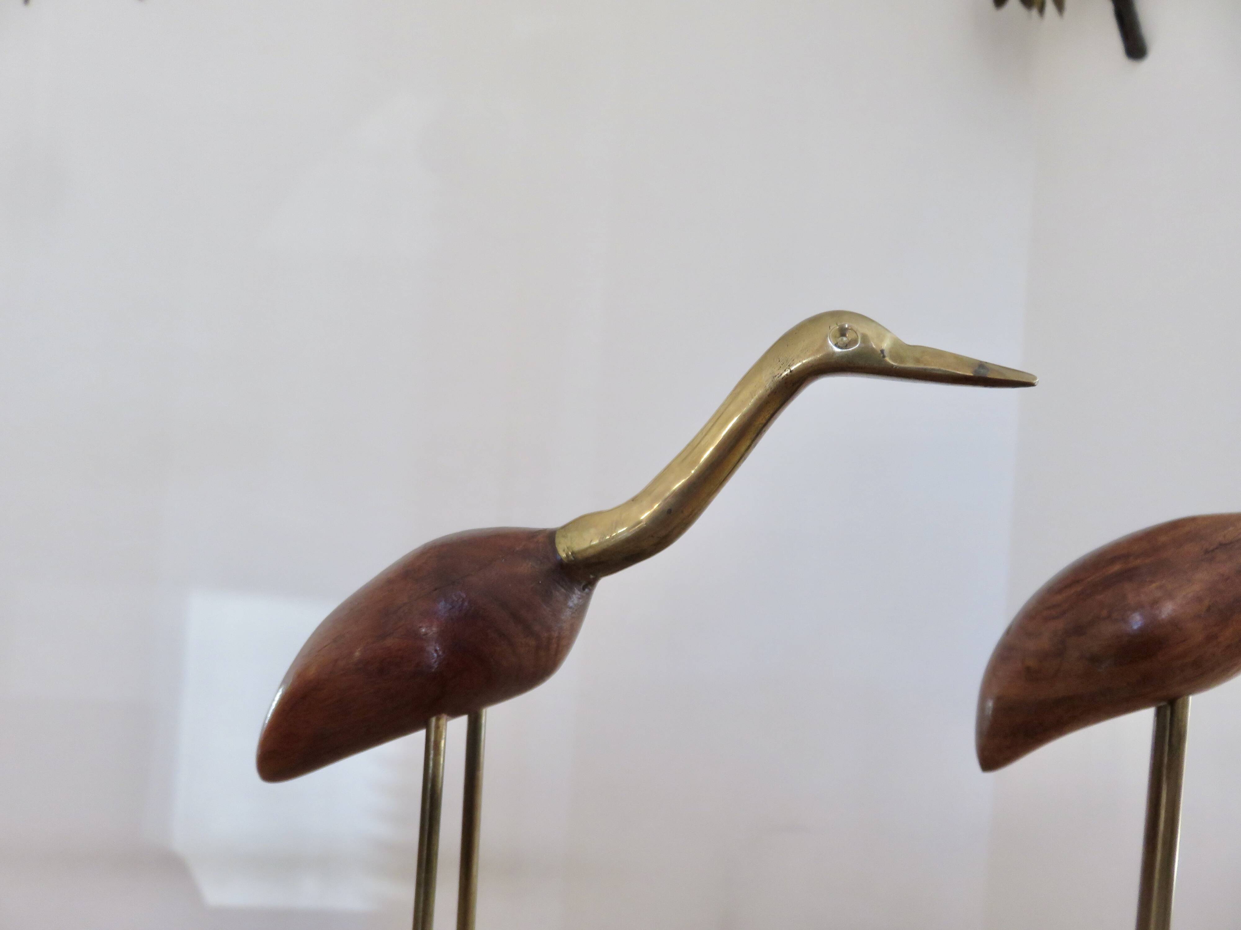 Pair of teak and brass herons from the 70s