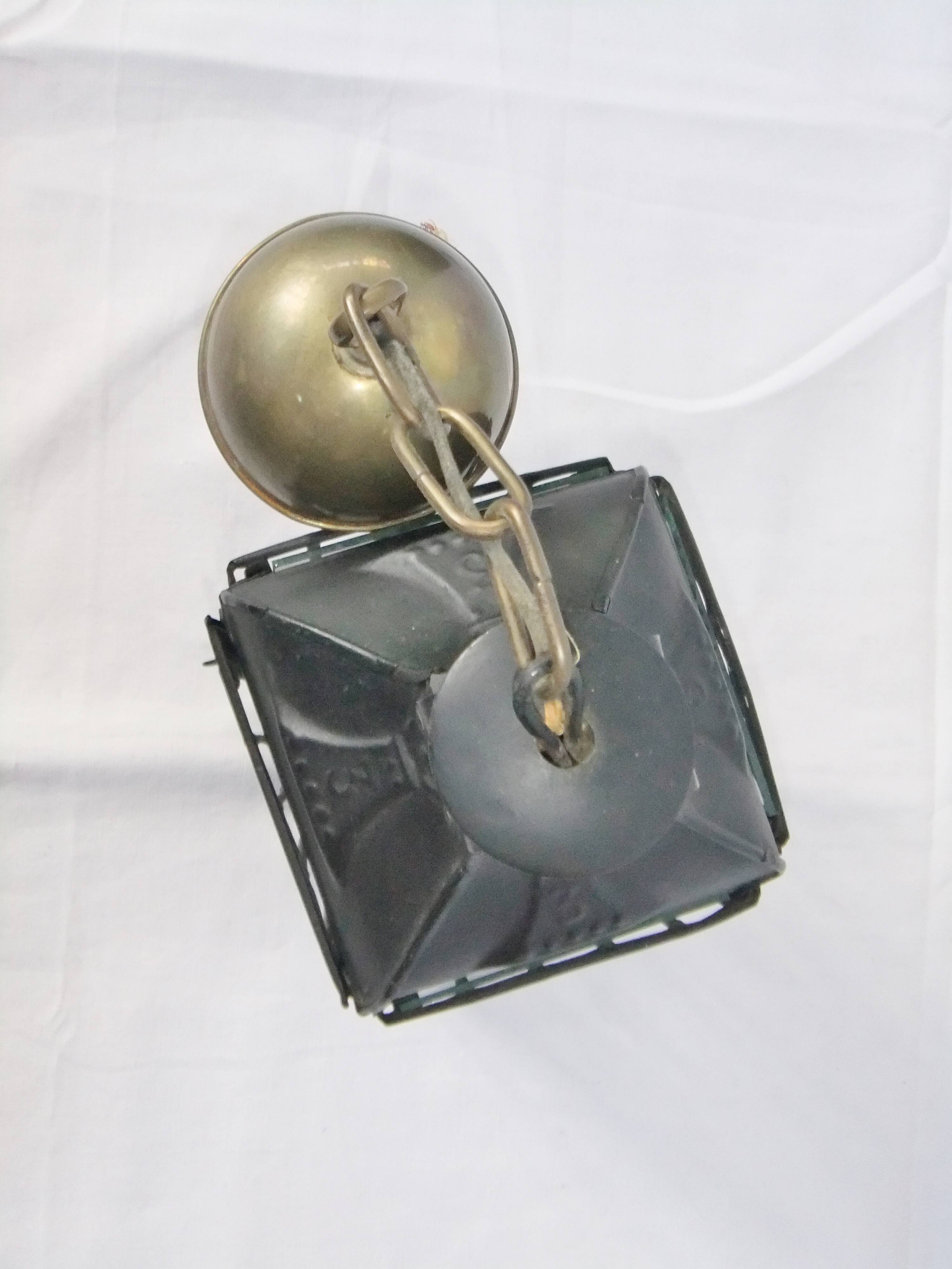Old chandelier hanging lantern with candle in sheet metal