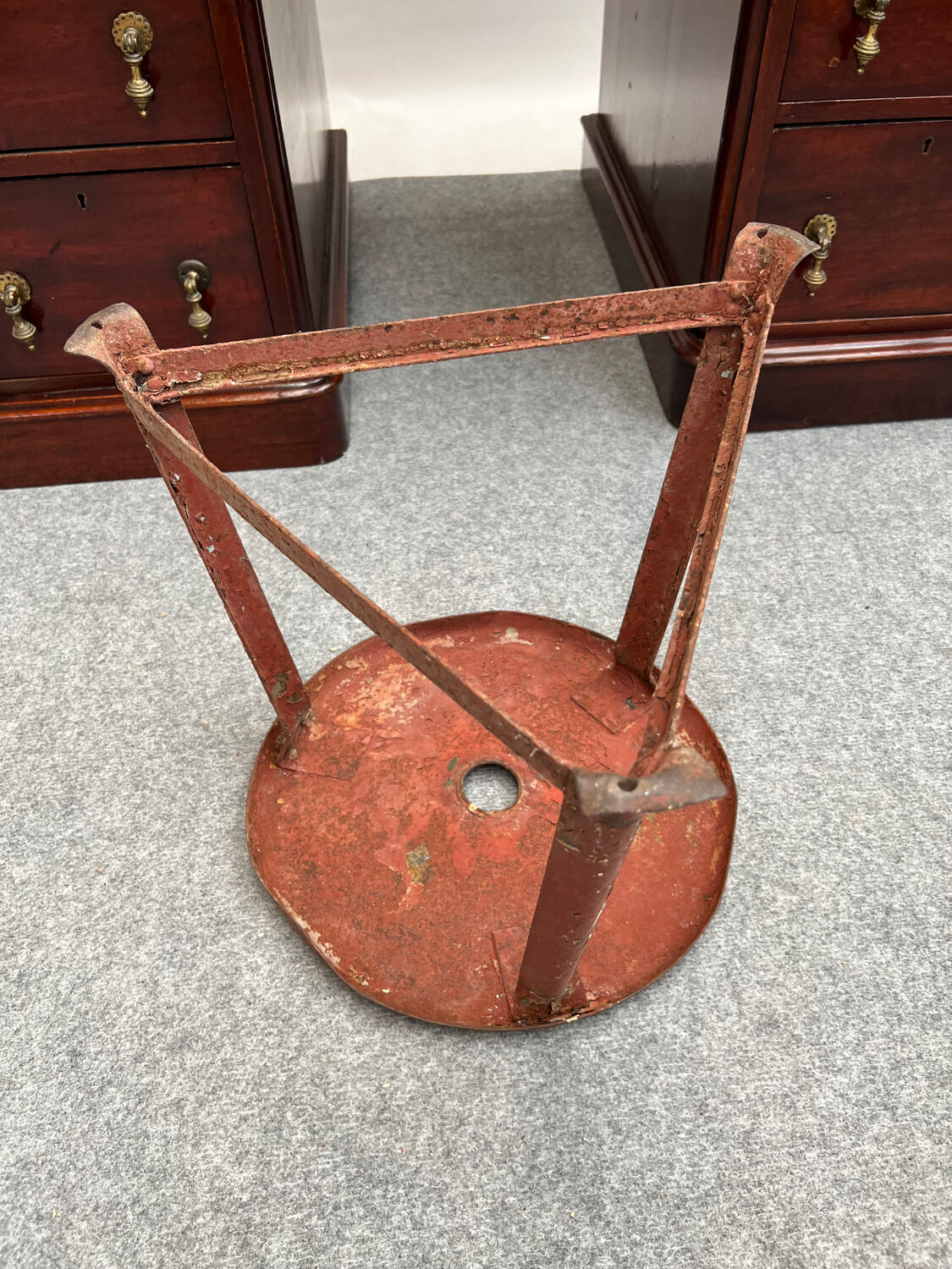 Red tripod industrial metal stool
