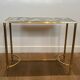 Pair of brass and antique mirror side tables from the Baguès house.