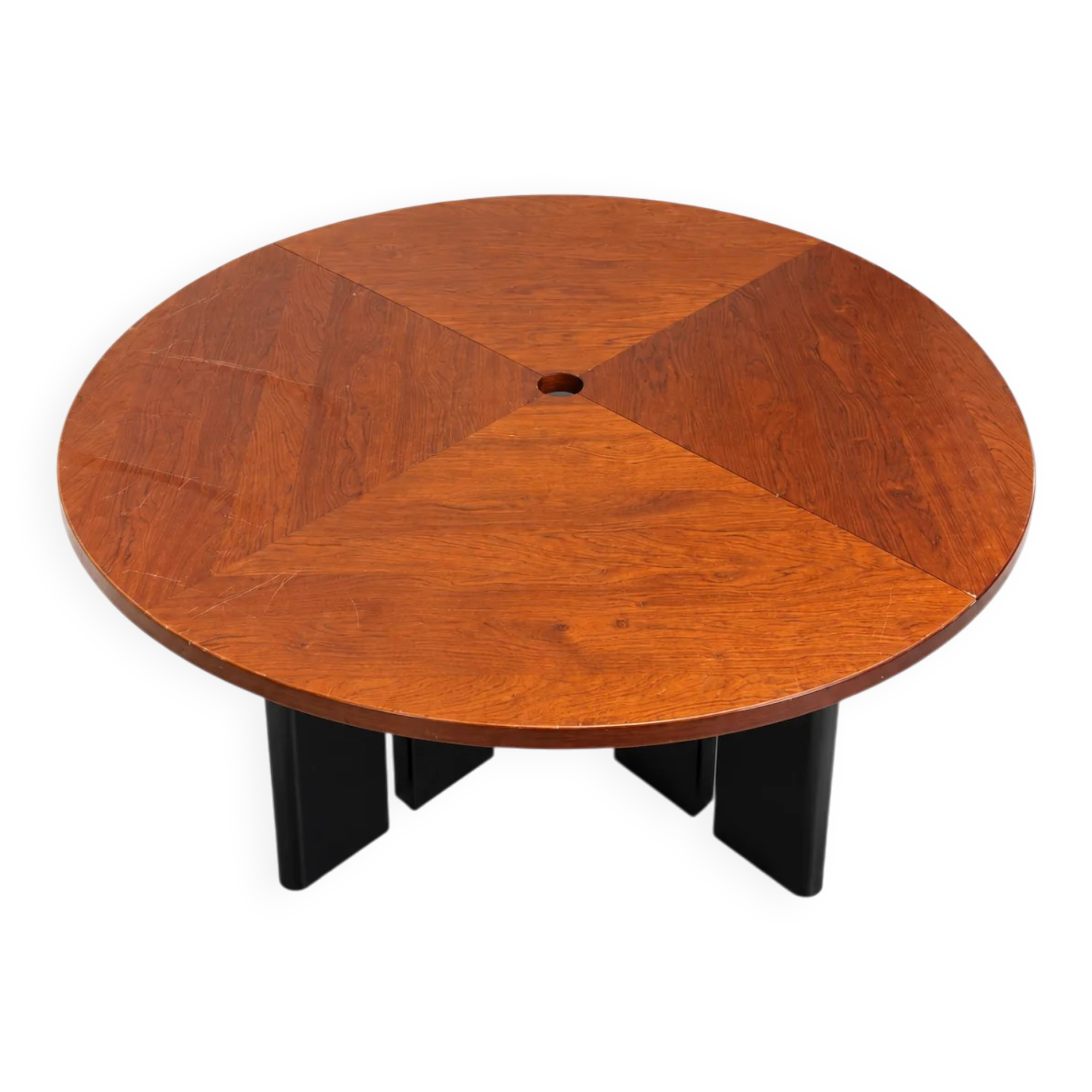 Large round dining table with black blade legs.
