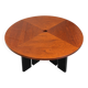 Large round dining table with black blade legs.
