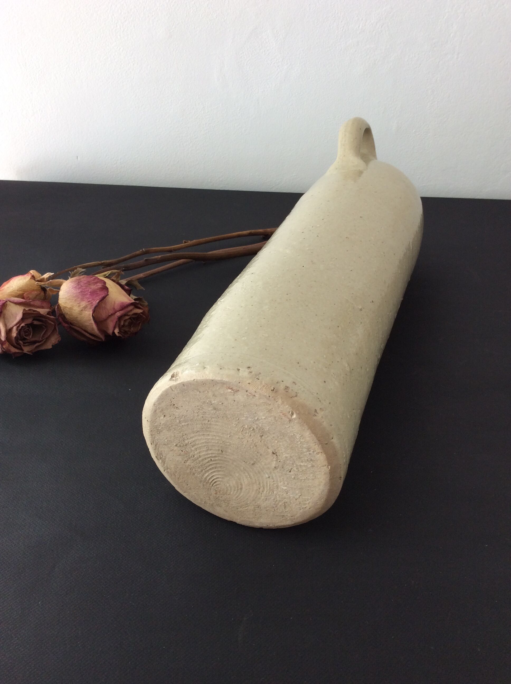 Old stoneware bottle with ear, loop