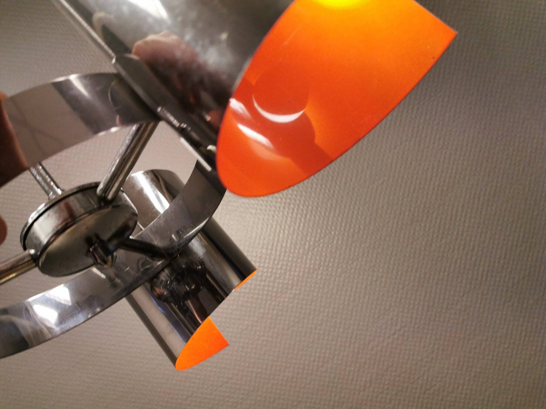 Hanging lamp in chromed metal with orange contrast lacquer and three light sources.
