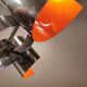 Hanging lamp in chromed metal with orange contrast lacquer and three light sources.