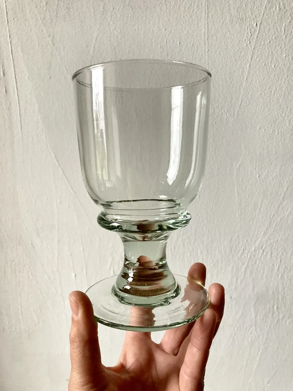 4 stemmed glasses made of handcrafted blown glass in green hue.