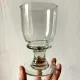 4 stemmed glasses made of handcrafted blown glass in green hue.