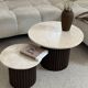 Round nesting coffee table in travertine and dark fluted wood.