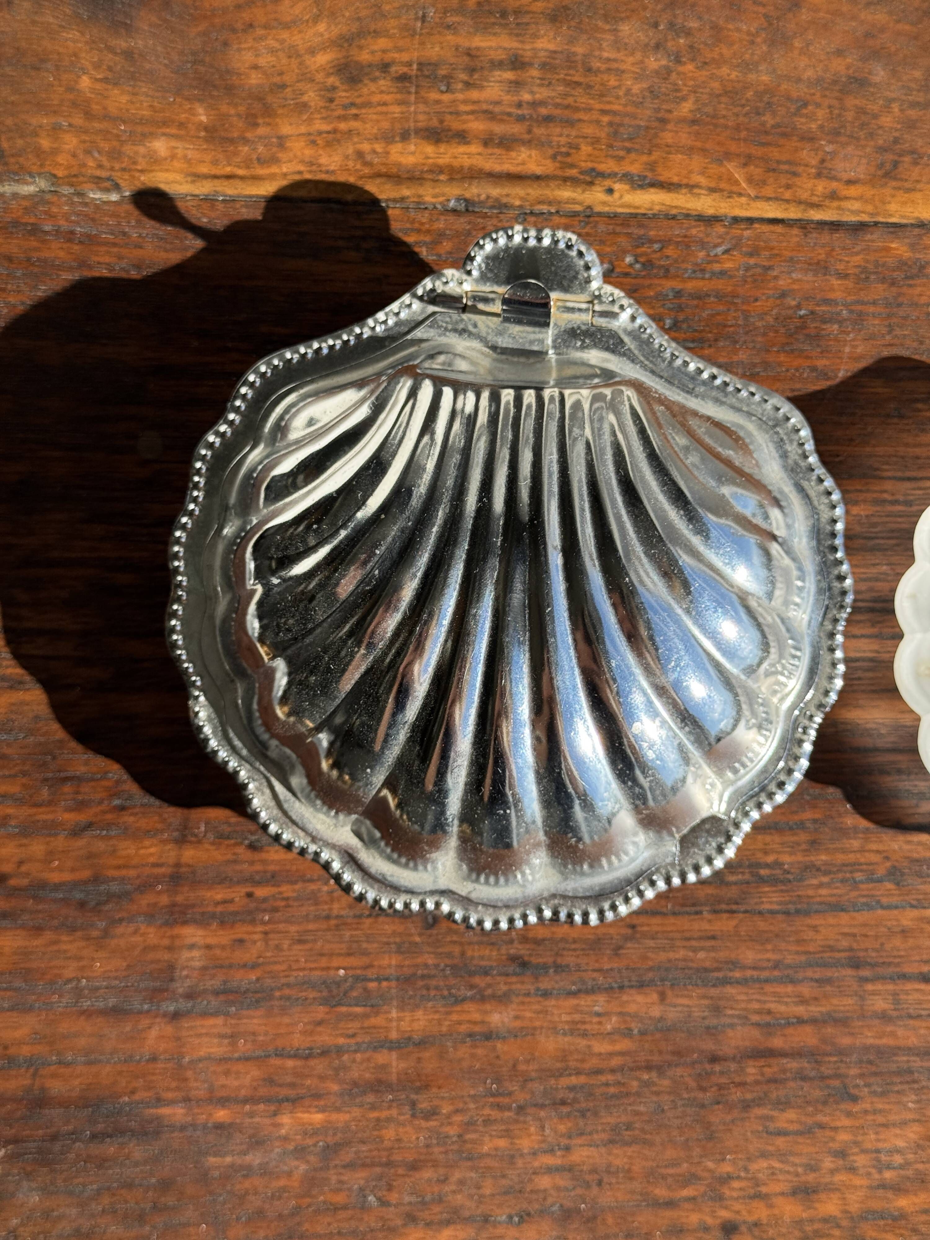 Vintage silver-plated shell butter dish with transparent bowl.