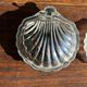 Vintage silver-plated shell butter dish with transparent bowl.