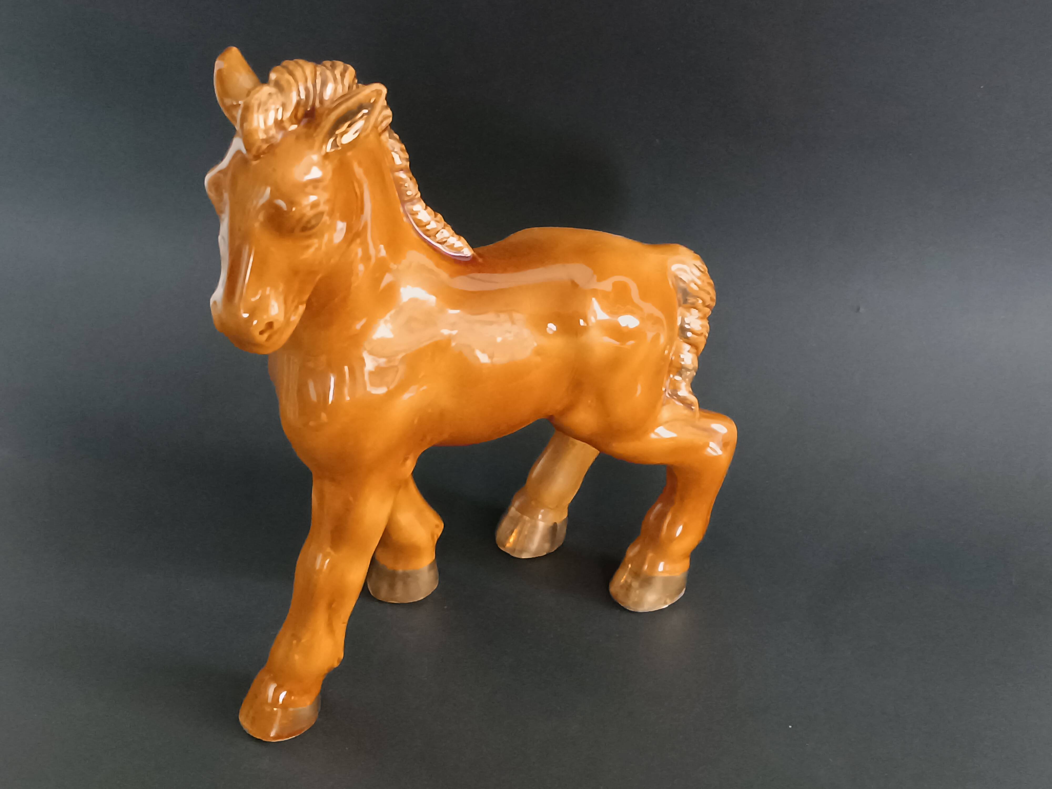 Ceramic horse sculpture with wild glaze and gold, signed Art Deco.