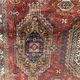 Antique wool rugs with designs on a red background, 20th century.