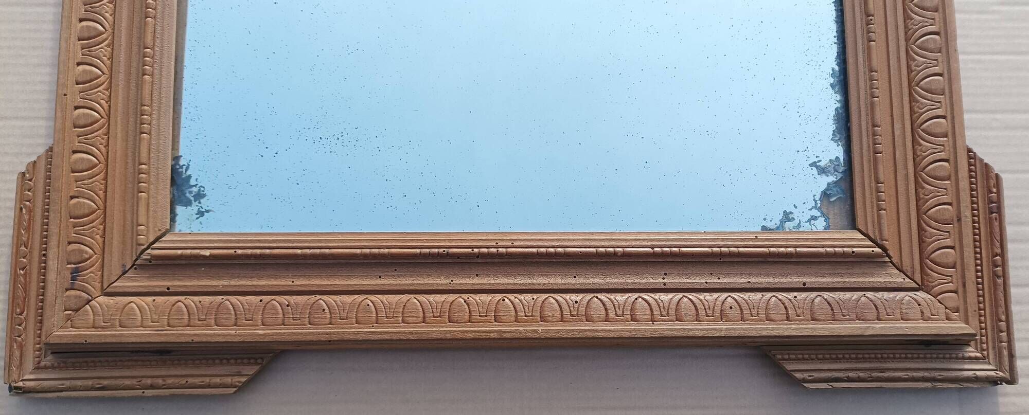 Louis XVI mirror in carved wood, 19th century.