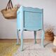 Small vintage bedside table in azure blue patina.