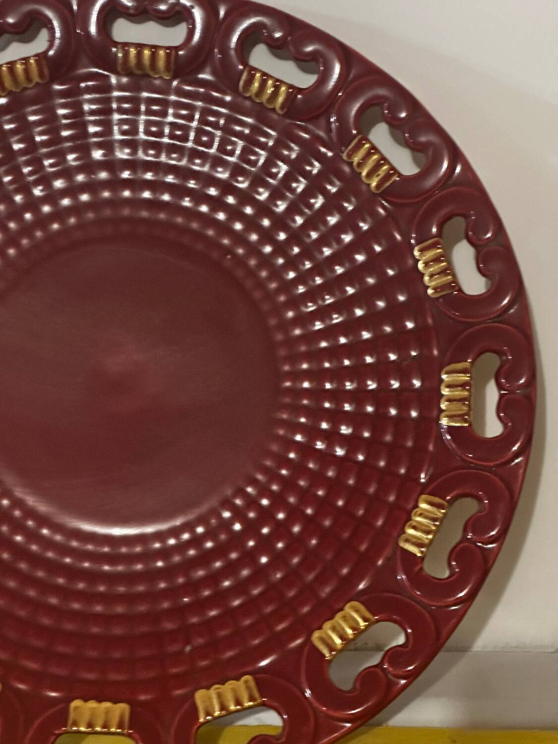 Burgundy and gold openwork plate in ceramic from Saint-Clement, 1950s.