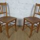oak tray table with cast iron legs and pair of bistro chairs