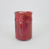 Red glazed ceramic jug with relief