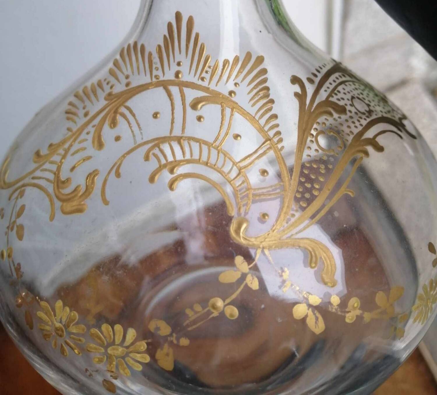 Old crystal decanter with gold decoration