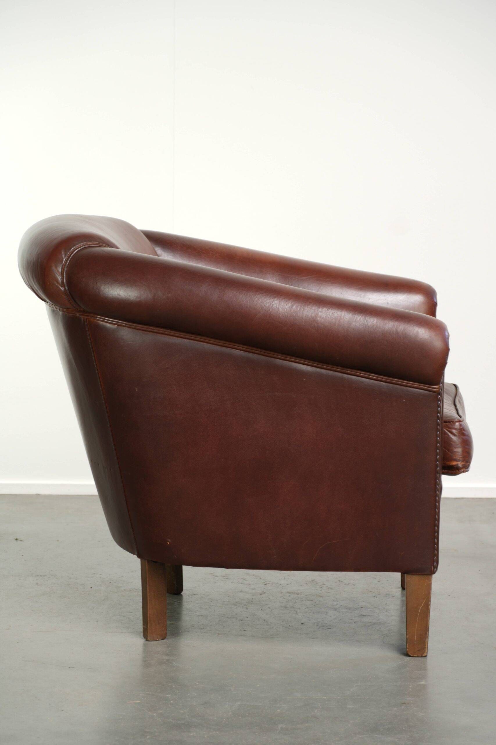 Sheepskin club armchair in English style with brown colour scheme