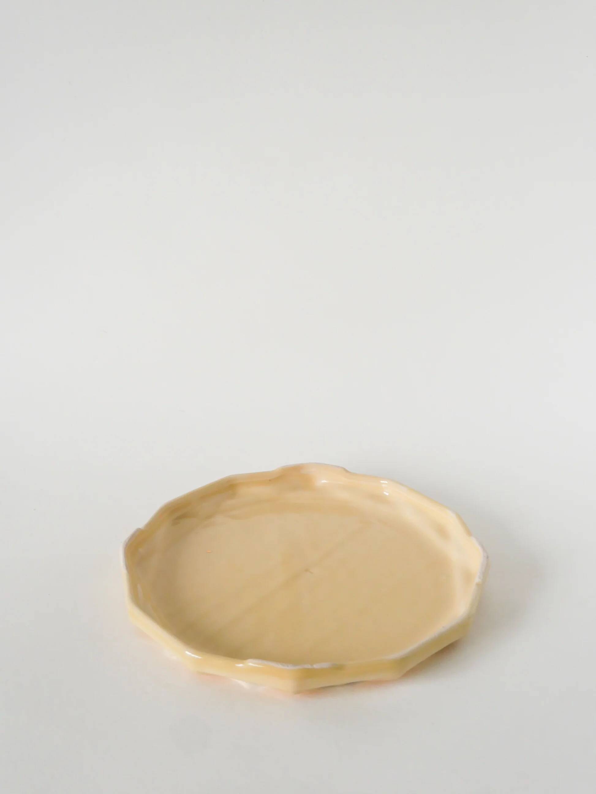 Ceramic trivet, butter yellow and gold, 1960.